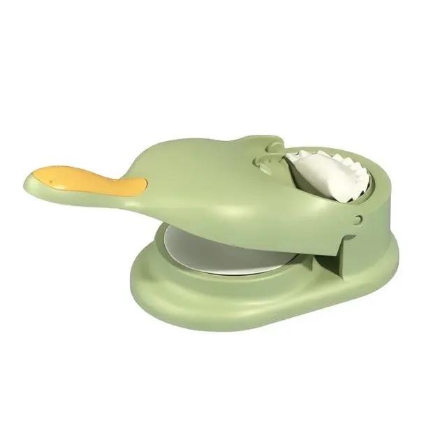 Single green 2-in-1 Knödel Teigtaschenformer with formed dumpling on white background