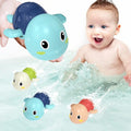 Baby enjoying bath with colorful Aufzieh-Schwimmschildkröten Badespielzeug swimming in water
