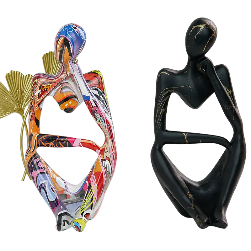 Colorful and black Abstrakte Denker Skulptur pair showing contrasting finish styles