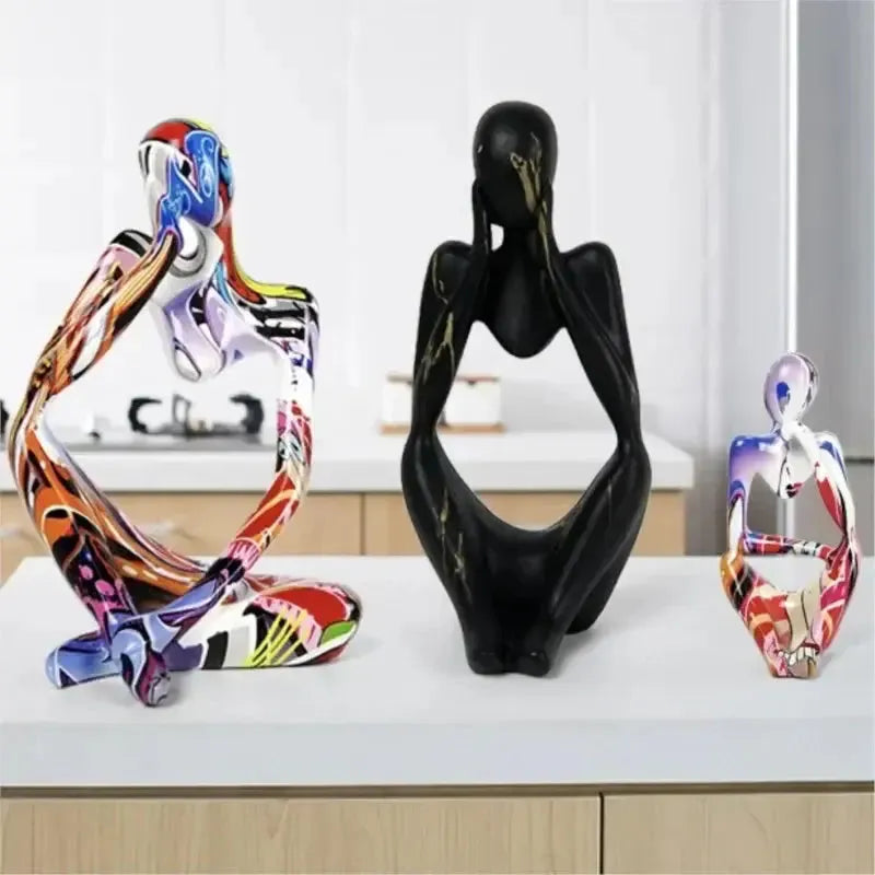 Three Abstrakte Denker Skulptur figurines in various sizes and colorful patterns