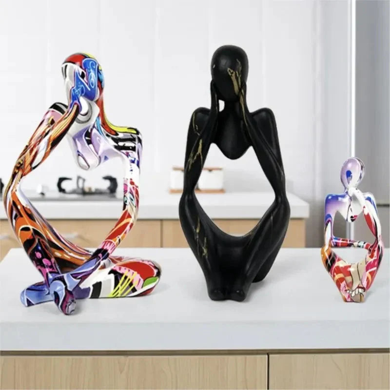 Three Abstrakte Denker Skulptur figurines in various sizes and colorful patterns