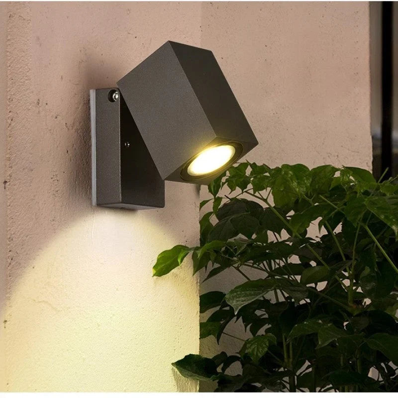 Outdoor wall light with integrated LED and adjustable swing arm