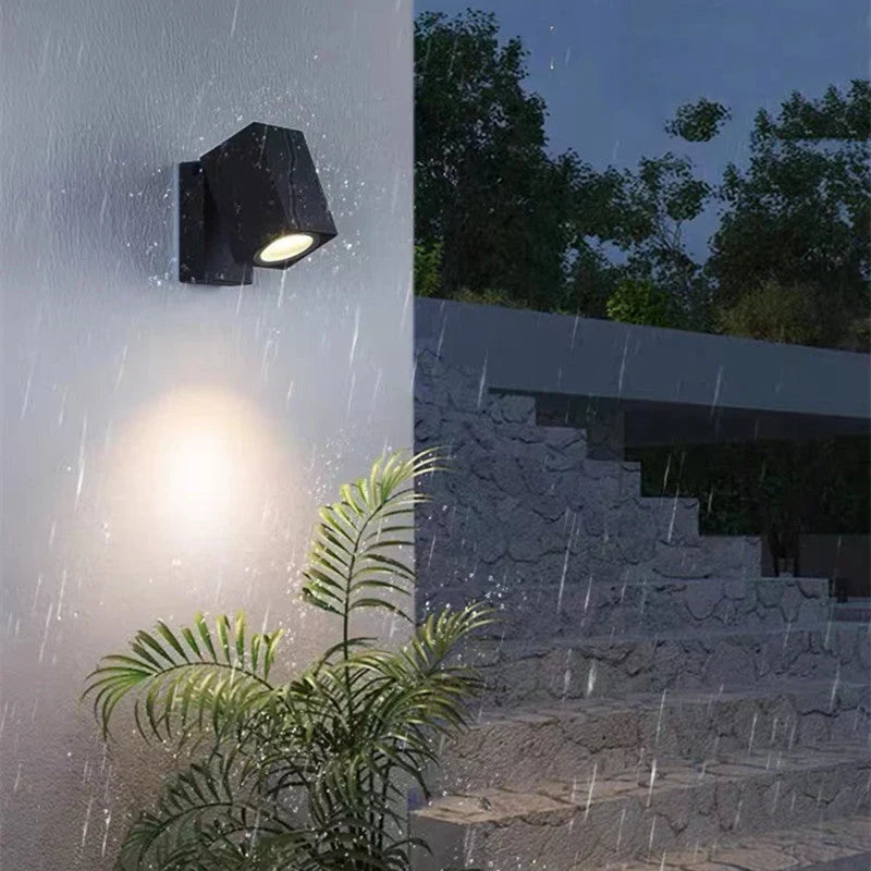 Outdoor wall light with integrated LED and adjustable swing arm
