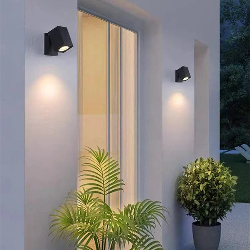 Outdoor wall light with integrated LED and adjustable swing arm