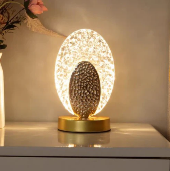 Table lamp with peacock design and crystal-like light reflections